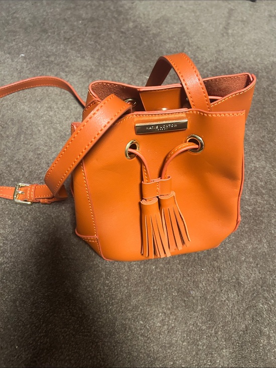 Katie Loxton Handbags - Contrast Stitch Orange Bucket Bag with Tassel Drawstring